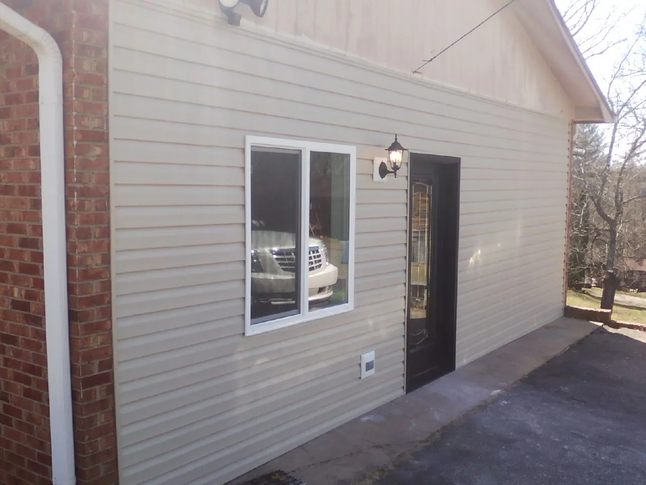 New vinyl siding and entry door on a room addition in Readyville