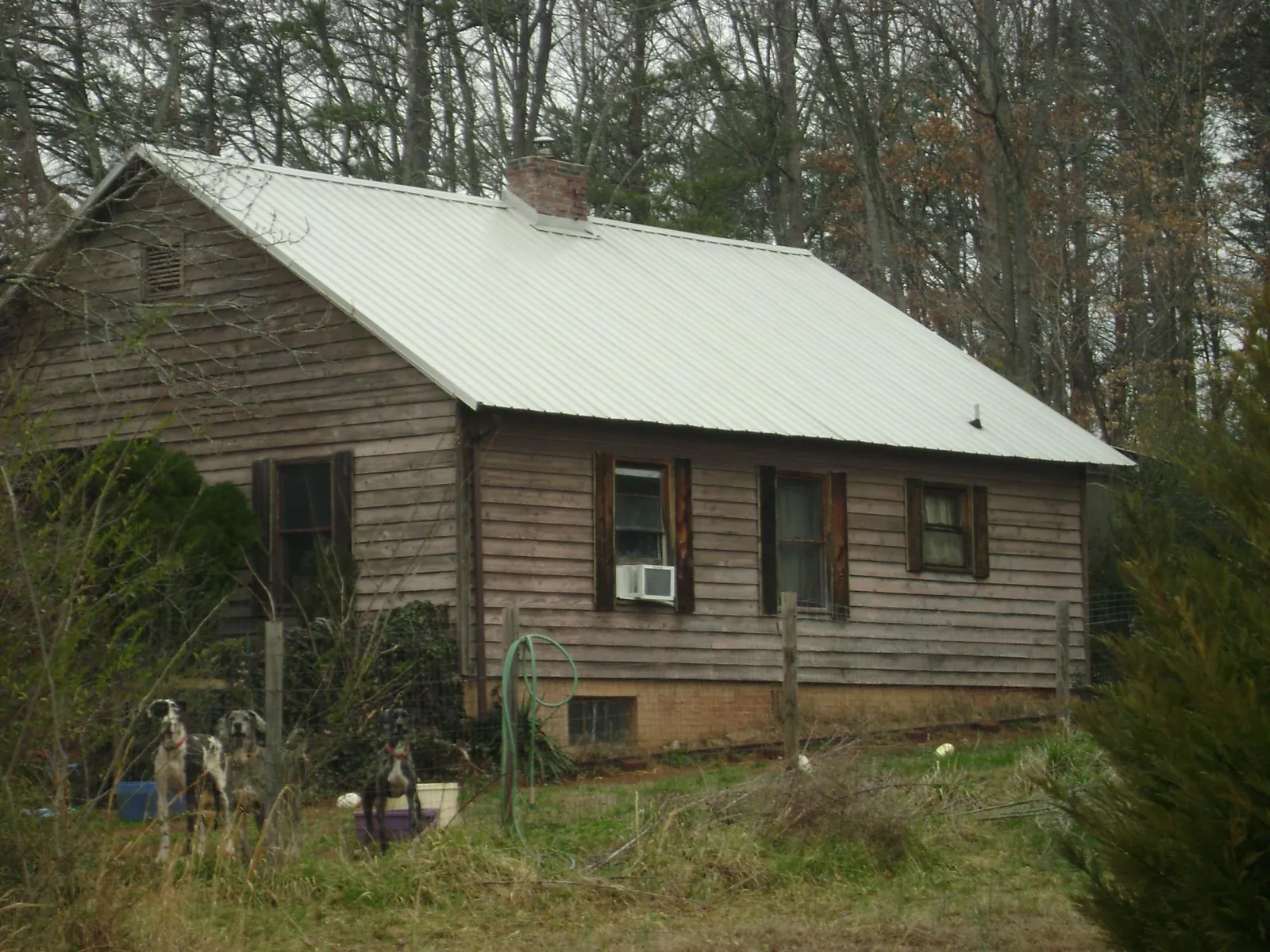 White metal roof on an old wood sided farmhouse, from a Metal Roof Installation job in Readyville